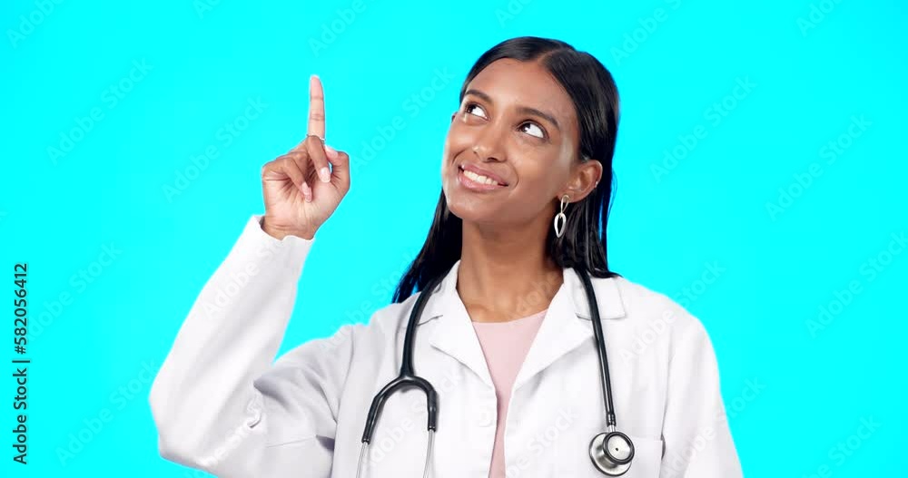 Healthcare doctor, smile and woman point at medical promotion, hospital notification or clinic announcement mockup. Nurse portrait, studio advertising surgeon and marketing female on blue background Healthcare doctor, smile and woman point at medical promotion, hospital notification or clinic announcement mockup. Nurse portrait, studio advertising surgeon and marketing female on blue background