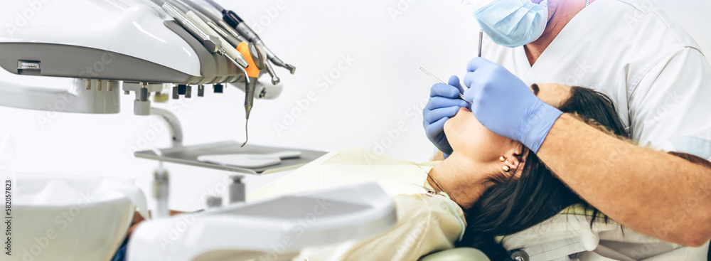 Dentist with patient in dental chair providing manipulations in oral cavity. Dentist with patient in dental chair providing manipulations in oral cavity.