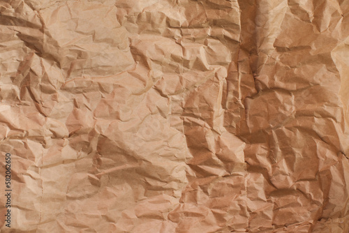 Background for design. Brown crumpled craft paper. The concept of using eco-friendly materials. Copy space