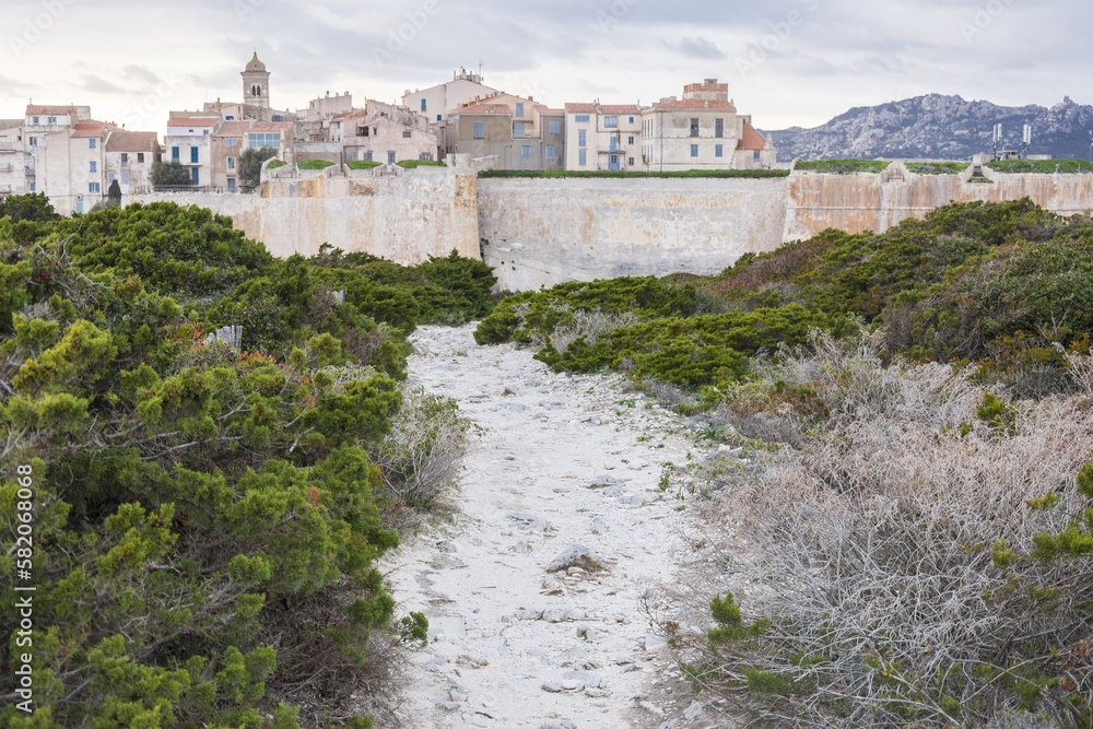 Hiking trail in the maquis leading to Bonifacio in Corsica during a cloudy summer
