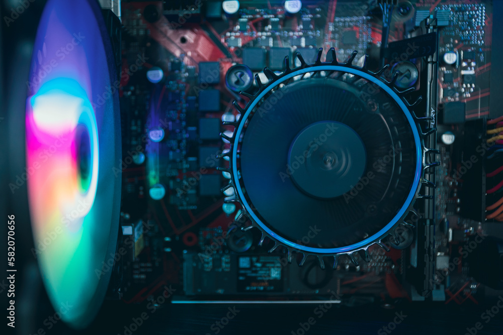 LED Inside a high performance computer. Computer circuit board and CPU cooling fans illuminated by internal LED LED Inside a high performance computer. Computer circuit board and CPU cooling fans illuminated by internal LED