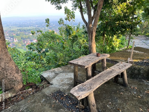Wooden table and bench in the park with beautiful panoramic nature on the background