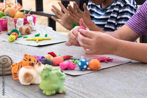 Different shapes and colors of plasticine of the LD children are molded and placed on a table in front of them to train, to concentrate and to increase their brain skills, soft and selective focus. photo