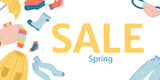 Wide banner spring sale with a composition of clothes on white background, raincoat, umbrella, jeans