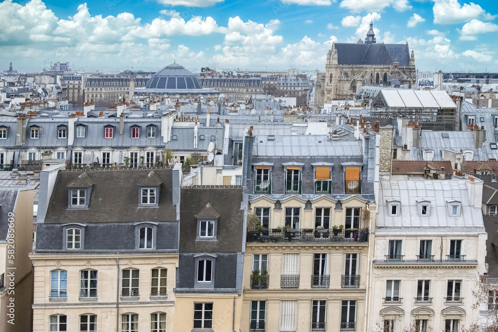 Paris, typical roofs in the Marais, aerial view with the Halles, the Saint-Eustache church and the Defense in background 
