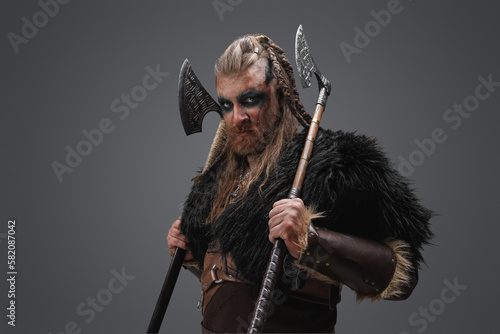 Portrait of antique barbaric warrior from nord dressed in leather armor and black fur.
