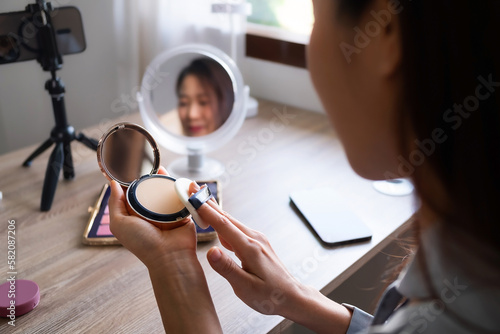 Beauty blogger, asian young woman, girl vlogger makeup face, showing, reviews cosmetics products while recording video, tutorial to share on social media. Business online influencer on smartphone