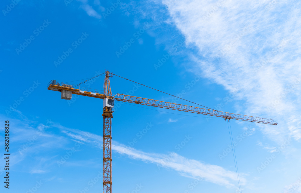 Construction crane and blue sky in background