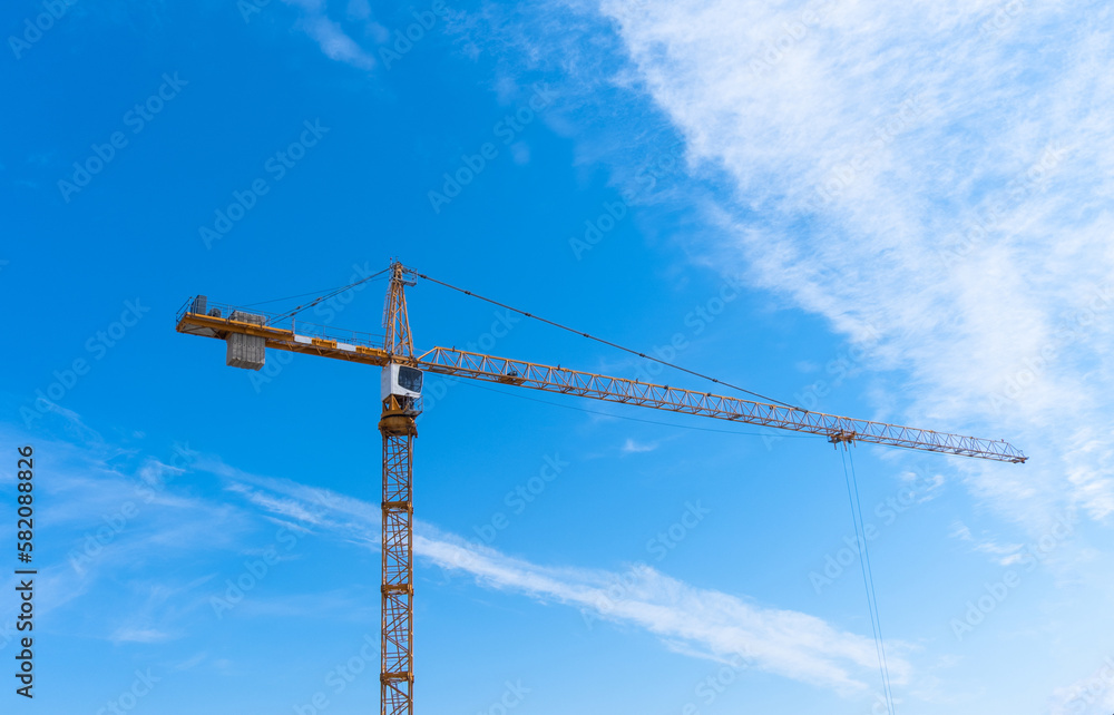Construction crane and blue sky in background Construction crane and blue sky in background