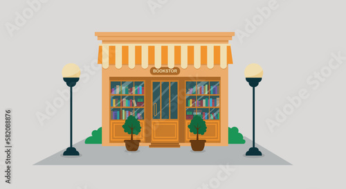 Bookstore with an awning above the entrance. Books in a shop window on shelves.