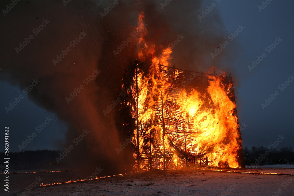 Fire. Russian Maslenitsa. Celebration of Maslenitsa 2023. Traditional national folk holiday in Nikola-Lenivets, Kaluga region, Russia. Russian landmark. Burning wooden castle
