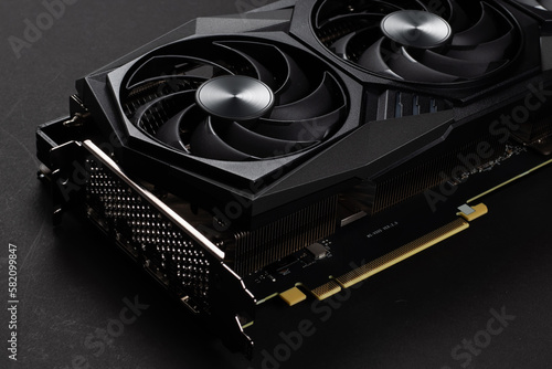 A close up of a modern GPU Graphic card on dark background.