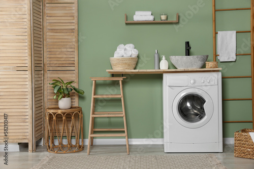 Stylish laundry room with functional washing machine. Interior design © New Africa
