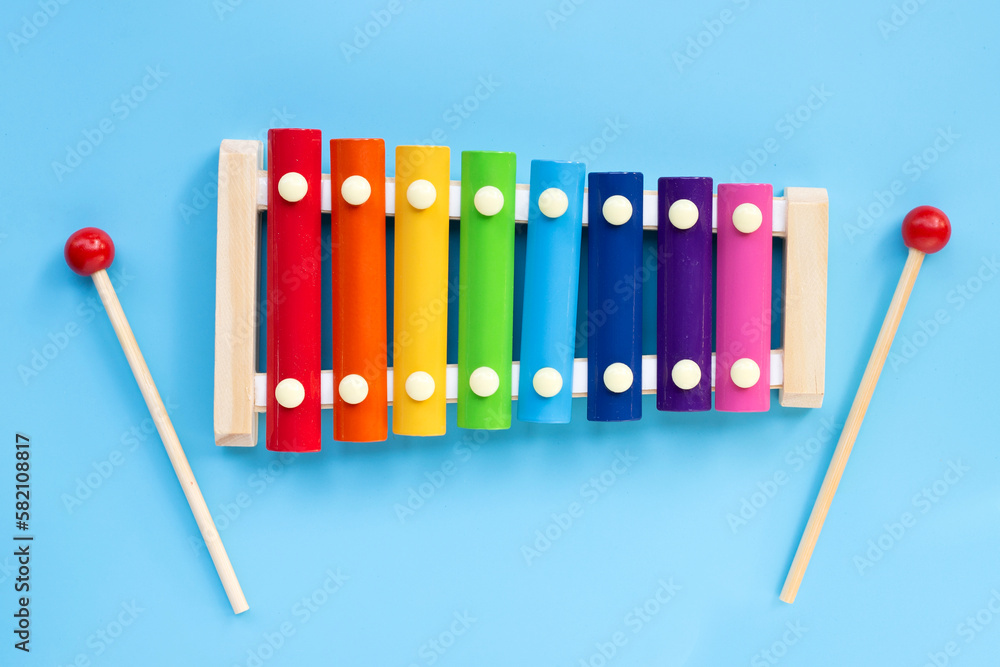 Colorful xylophone on blue background. Stock Photo | Adobe Stock