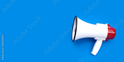 Red and white megaphone on blue background.