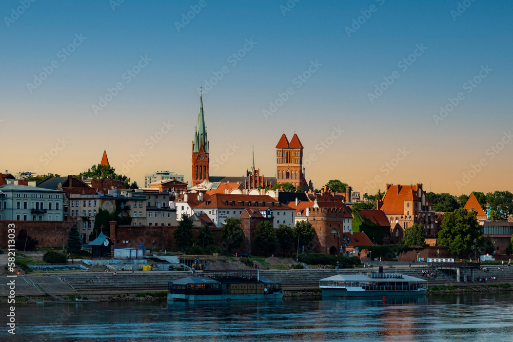 04-07-2022: View of Old City of Torun. Vistula (Wisla) river against the backdrop of the historical buildings of the medieval city of Torun. Poland.