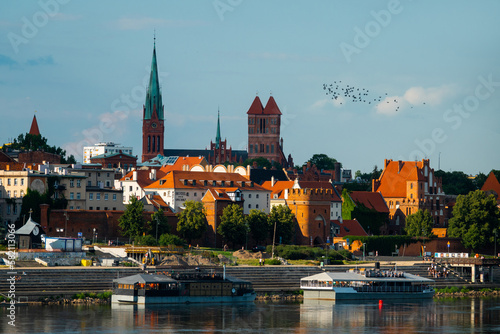  04-07-2022: View of Old City of Torun. Vistula (Wisla) river against the backdrop of the historical buildings of the medieval city of Torun. Poland. Europe