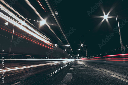 city street at night with vehicles light trails