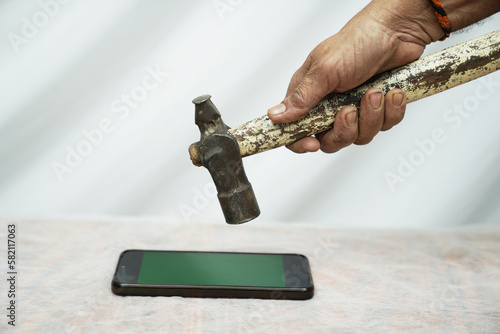 mobile phone breaking, smartphone, display breaks, breaking with hammer, addiction, cellphone, closeup, concept, concepts, crashed, crime, criminal, cyber, damaged, danger, declining, display, equipme photo