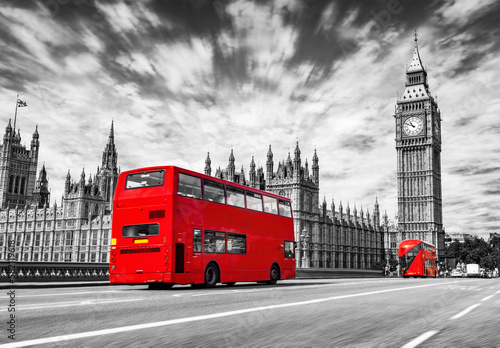 Red bus on Westminster bridge next to Big Ben in London, the UK. Black and white photo