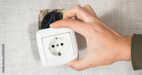 Dangerous bad,broken socket,plug in bathroom,falling out of wall. Outlet installation in old apartment. Poor electrical wire,repair.Terrible do-it-yourself repairmen.Short circuit risk,electric shock