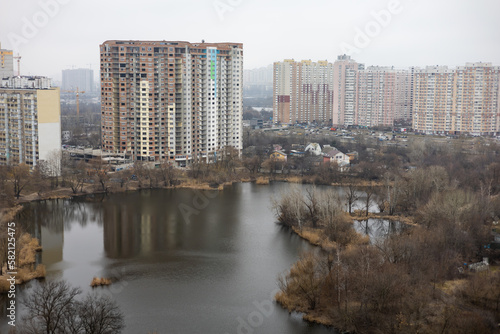 Soviet prefabricated multi-storey apartment building near lake in Kyiv, Ukraine.
