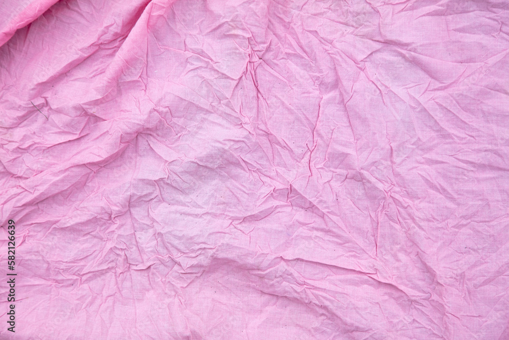 Fototapeta premium (Несколько значений)Pink crumpled fabric as a background.