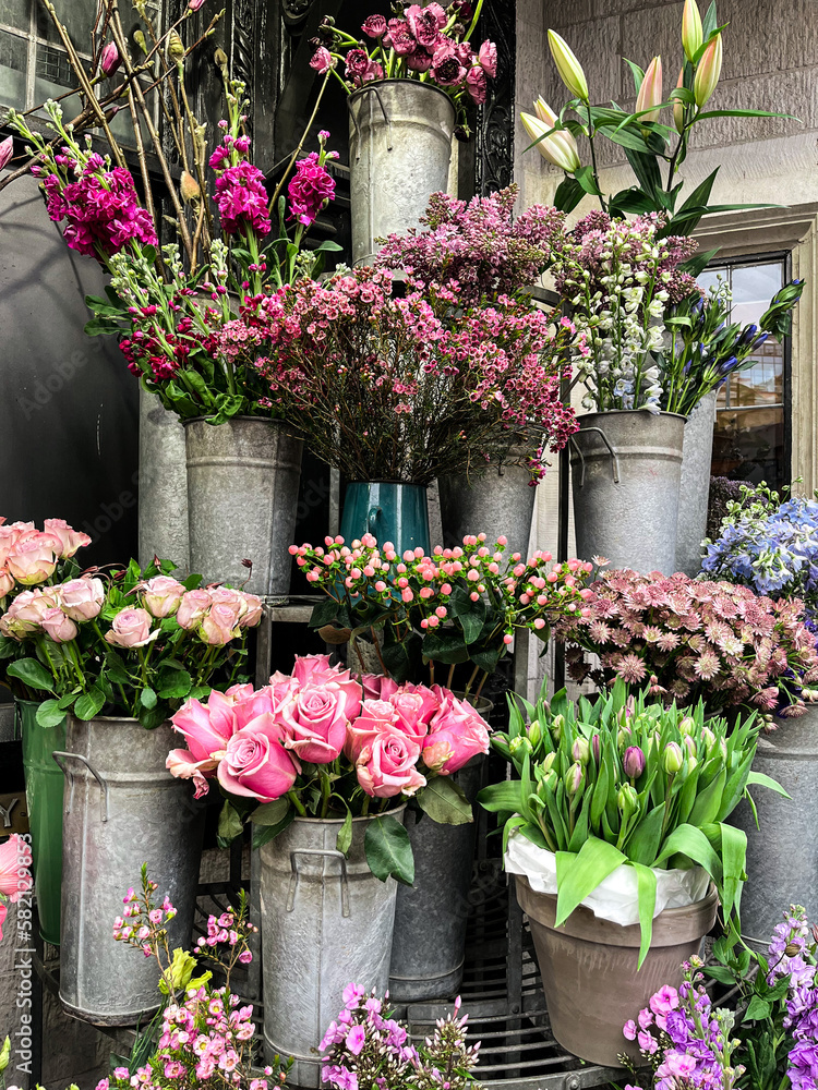 Bright flower stalls somewhere in London. Roses, tulips, and all other vibrant flowers placed in buckets and bouquets. These are the beauty for the eye. Bright flower stalls somewhere in London. Roses, tulips, and all other vibrant flowers placed in buckets and bouquets. These are the beauty for the eye.