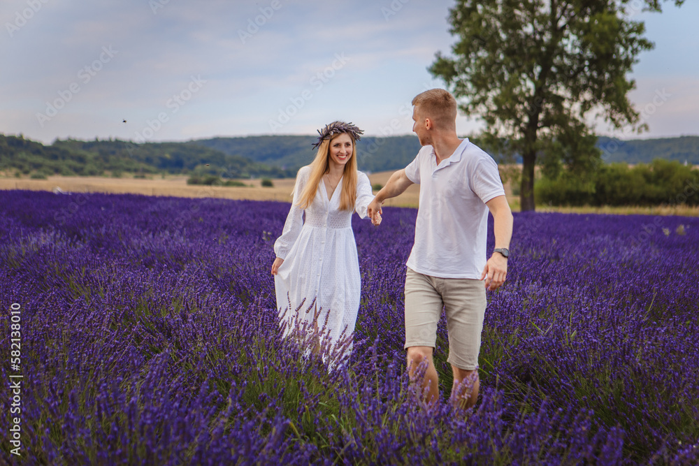 a couple in love is walking in a lavender field
