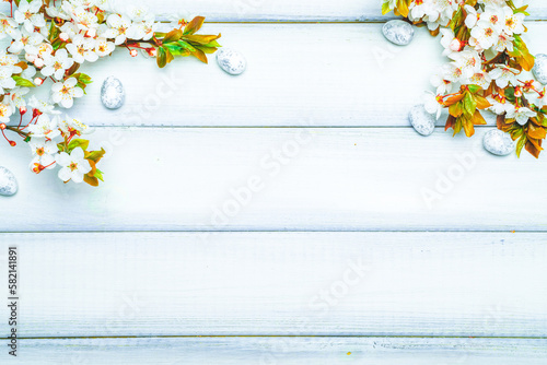 Easter white background. Spring flower border  white happy easter egg on wooden spring background. Easter card. Flat lay.