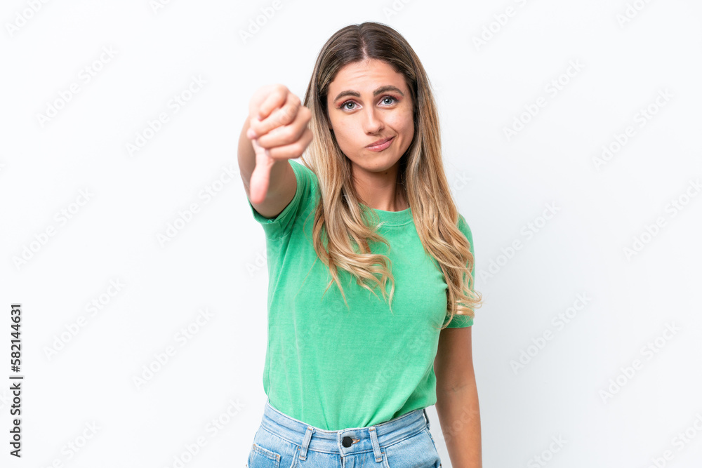 Young Uruguayan woman isolated on white background showing thumb down with negative expression Young Uruguayan woman isolated on white background showing thumb down with negative expression