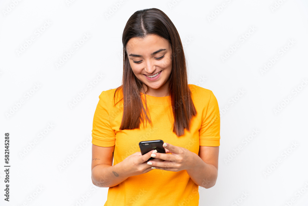 Young caucasian woman isolated on white background sending a message with the mobile Young caucasian woman isolated on white background sending a message with the mobile