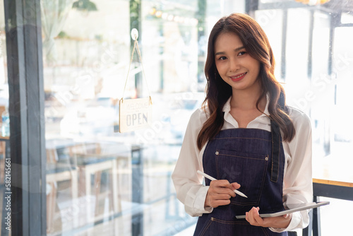 Portrait of a woman, a coffee shop business owner smiling beautifully and opening a coffee shop that is her own business, Small business concept..