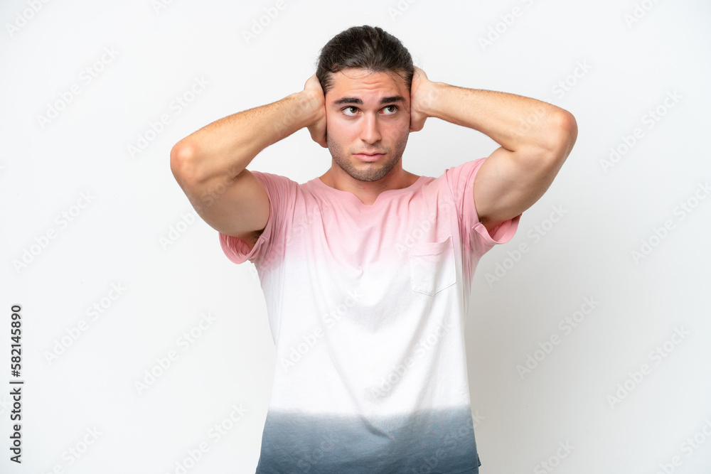 Caucasian handsome man isolated on white background frustrated and covering ears Caucasian handsome man isolated on white background frustrated and covering ears