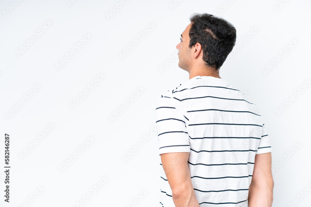 Young caucasian man isolated on white background in back position and looking back Young caucasian man isolated on white background in back position and looking back