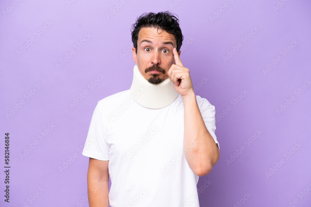Young caucasian man wearing neck brace isolated on purple background thinking an idea Young caucasian man wearing neck brace isolated on purple background thinking an idea
