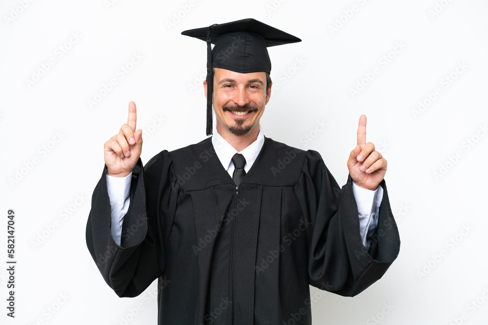Young university graduate man isolated on white background pointing up a great idea Young university graduate man isolated on white background pointing up a great idea