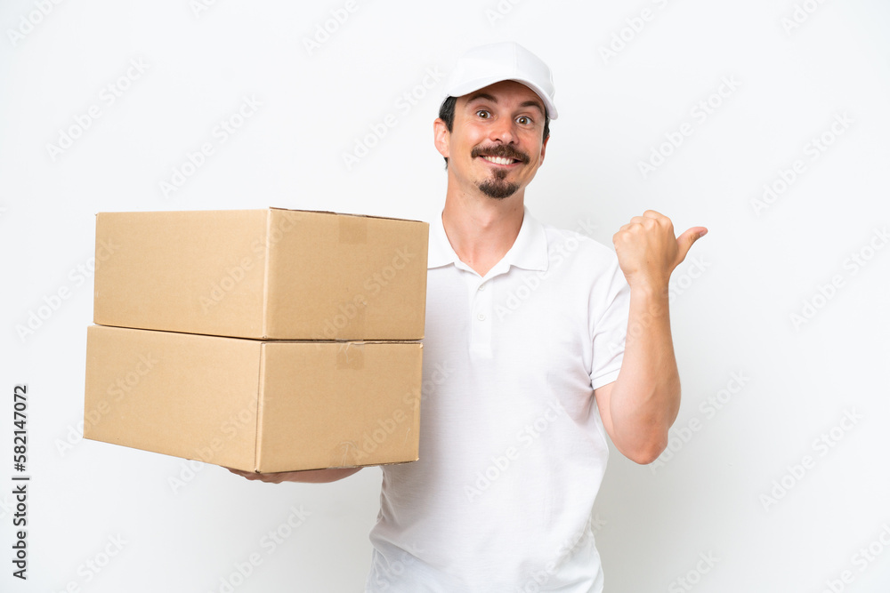 Delivery caucasian man isolated on white background pointing to the side to present a product Delivery caucasian man isolated on white background pointing to the side to present a product