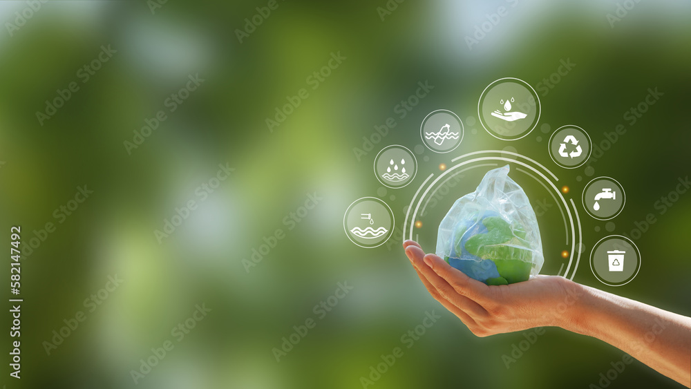 Concept of ecology and world water day . Hand holding the earth that plastic bag covering on a green background with i cons. save water, world water day.World Earth day, environment day. Concept of ecology and world water day . Hand holding the earth that plastic bag covering on a green background with i cons. save water, world water day.World Earth day, environment day.