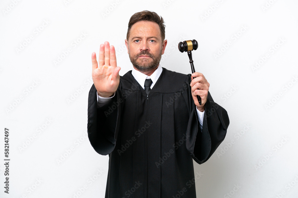 Middle age judge man isolated on white background making stop gesture Middle age judge man isolated on white background making stop gesture