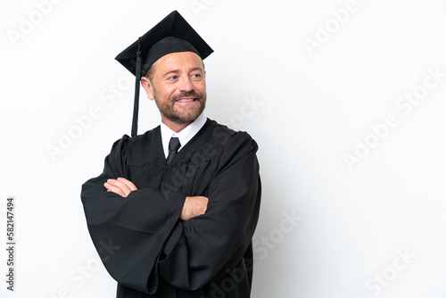 Middle age university graduate man isolated on white background with arms crossed and happy