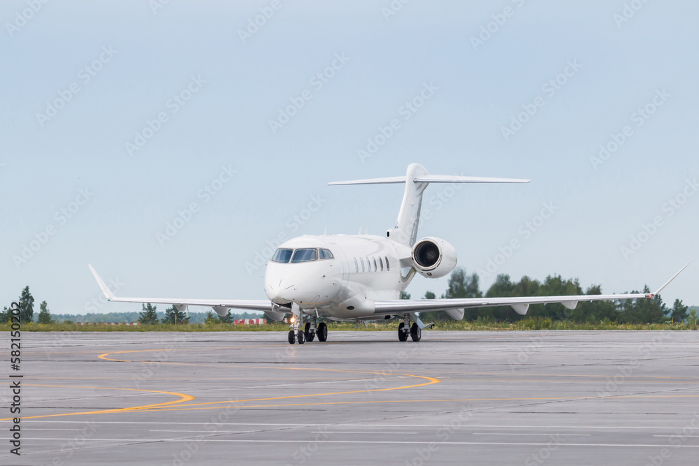 White luxury private jet taxiing on airport taxiway White luxury private jet taxiing on airport taxiway