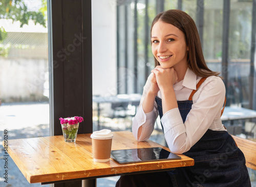 Portrait of a woman, a coffee shop business owner smiling beautifully and opening a coffee shop that is her own business, Small business concept..