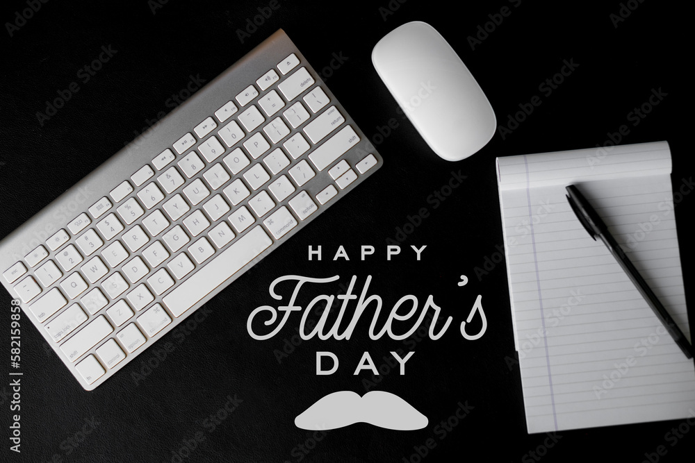 happy father's day text on modern office desk workspace with white keyboard and mouse and black ...