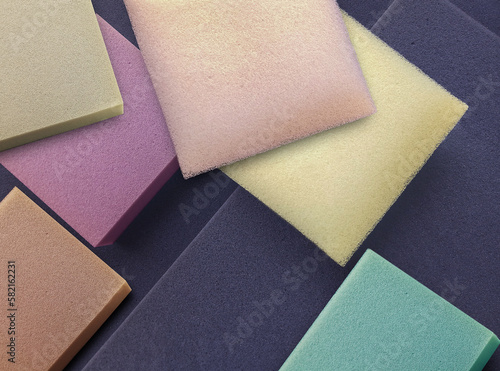 colorful square sponge foam pieces neatly arranged in a square shape. a collection of pastel colored soft materials with different thicknesses