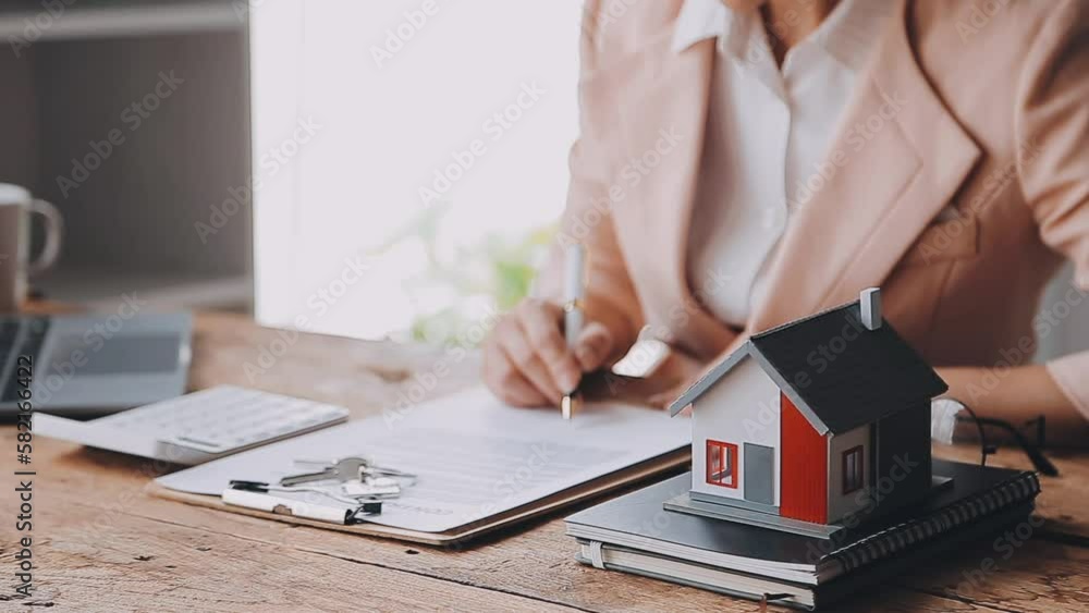 Real estate broker agent presenting and consult to customer to decision making sign insurance form agreement, buy and sell home model, concerning mortgage loan offer for and house insurance