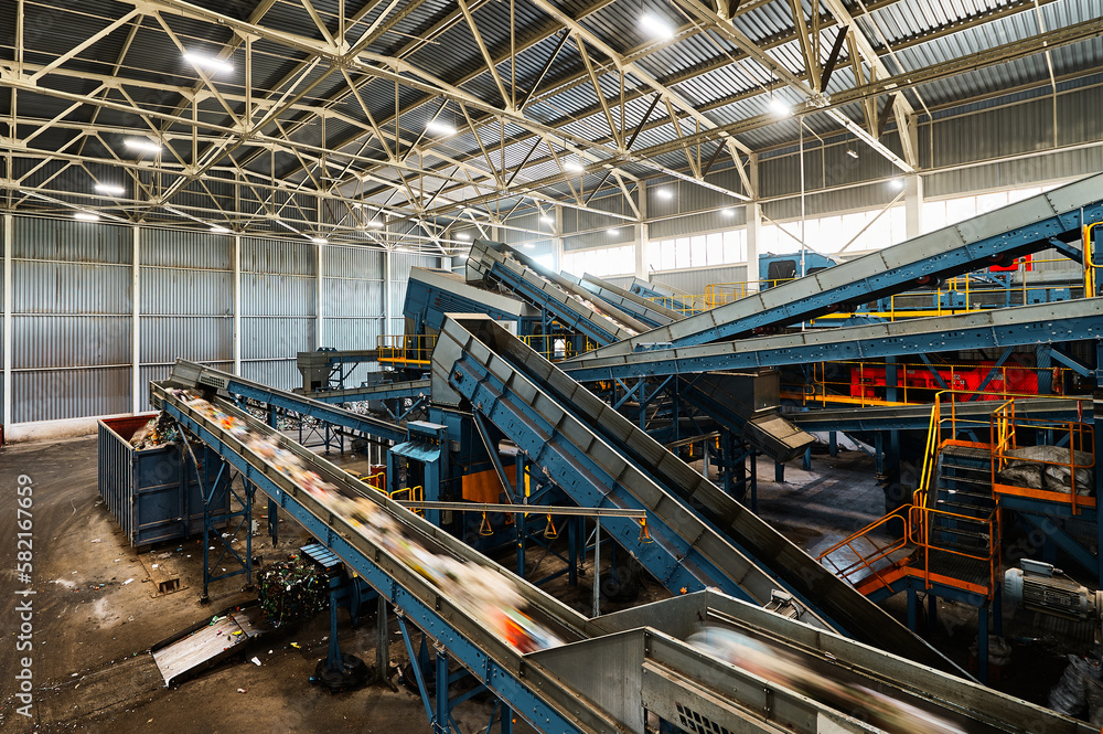 Conveyor carries trash pieces in recycling plant workshop
