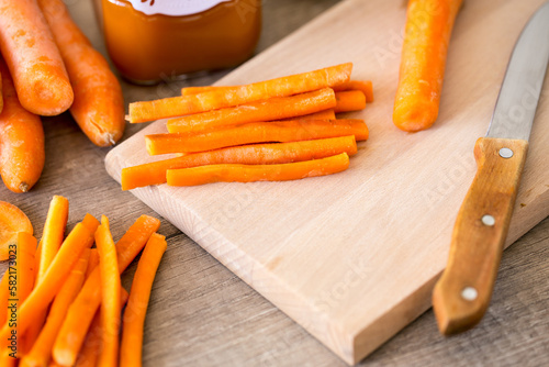 Carrots sticks on wooden board.