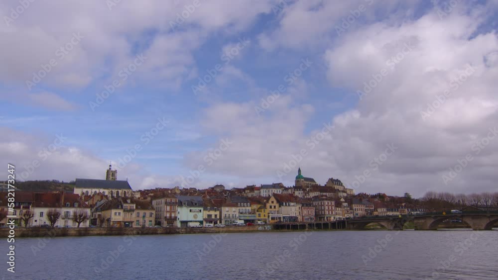 View of a beautiful street and houses with old traditional French houses in the center of Joigny with clouds in the background. Legacy of French history. Historic hotels, colorful houses in France View of a beautiful street and houses with old traditional French houses in the center of Joigny with clouds in the background. Legacy of French history. Historic hotels, colorful houses in France