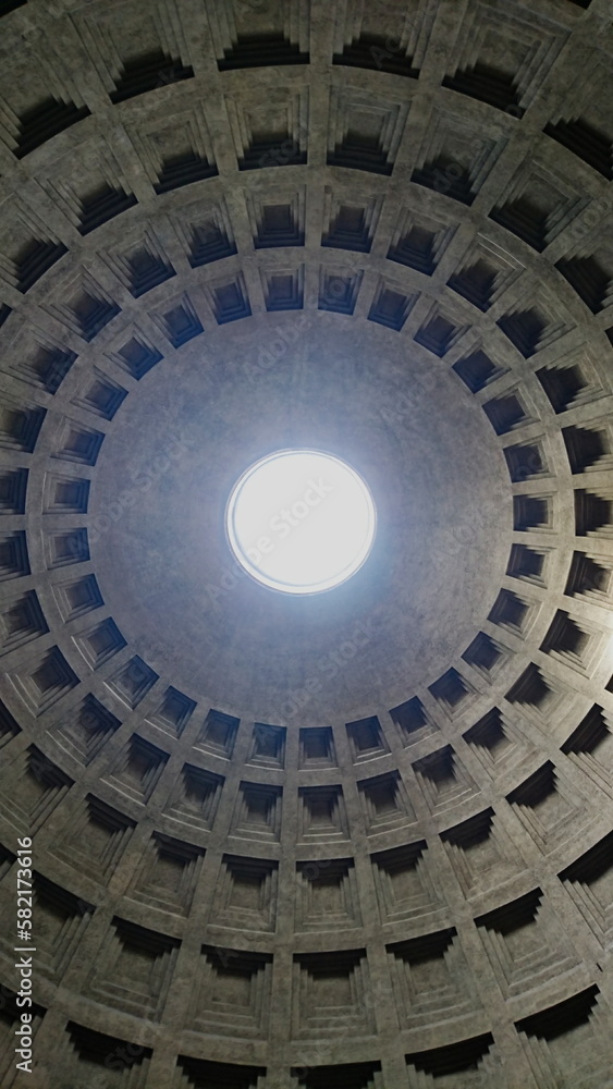 Rome, Italy - Apr 04 2018: Light passing through the oculus of the ceiling of the Pantheon on a sunny day